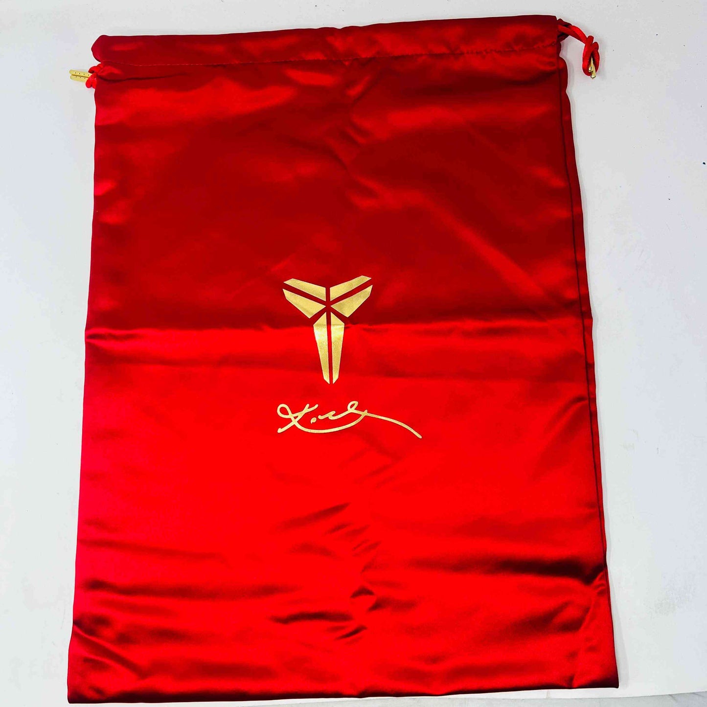 The Nike Kobe 5 Protro Year of the Mamba Eggplant sneakers offer a stylish design with purple and gold colors, black laces, and an authentic tongue logo. They feature perforated side panels, a shiny finish, and include a dust bag for easy storage.