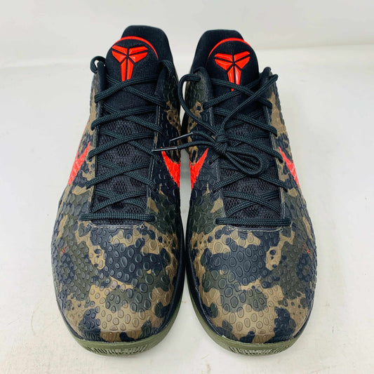 The 2024 Nike Kobe 6 Protro Italian Camo features a textured gray upper with a bright red swoosh, sits on a black shoe box, and has a greenish midsole labeled Zoom. The sleek black lace system completes this authentic sporty sneaker.