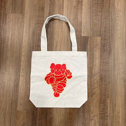 KAWS CHUM Tote Bag in red design on a new white canvas background.