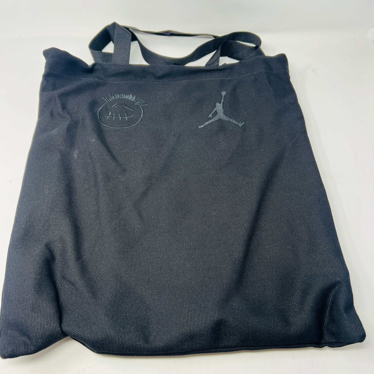A pair of Jordan Jumpman Jack TR Travis Scott Dark Mocha sneakers are showcased on a brown box labeled JACK in white. The brown and black sneaker features a black swoosh, laces, and textured sole. Its 100% authentic with extra laces and bag, set against a plain white background.