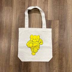 KAWS CHUM Tote Bag Yellow, brand new condition, featuring iconic yellow design on beige canvas.