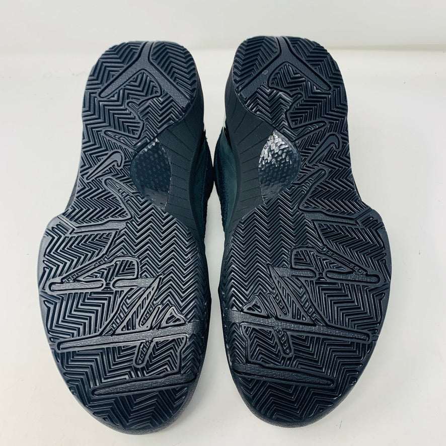 A brand new Nike Kobe 4 Protro Gift of Mamba sneaker in black, featuring a textured design with glossy and matte elements and prominent swoosh logo, is showcased atop its matching shoebox. Distinct patterns on the side and heel capture the essence of 2023s authentic shoe style.