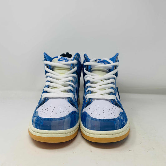 The Nike SB Dunk High Carpet Company sneakers feature a blue and white starry design, presented on a green and yellow Nike shoe box. Three extra laces in blue, yellow, and white are included to ensure your style is 100% authentic.