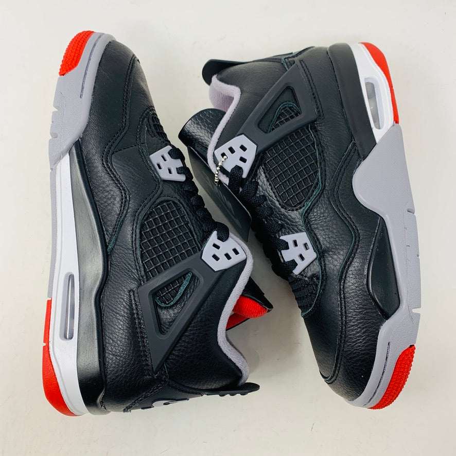 Jordan 4 Retro Bred Reimagined (GS) sneakers in black and red with leather and mesh upper, featuring Jumpman logo.