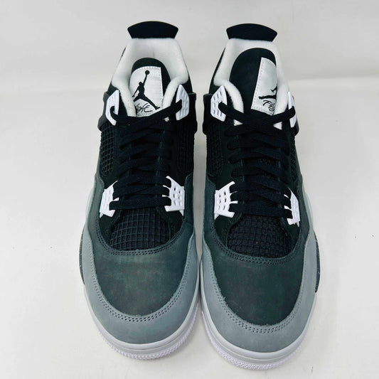 On top of a shoebox sits the brand-new Jordan 4 Retro Fear (2024), a stylish sneaker by Jordan. Its black and gray color scheme, black mesh accents, white midsole, and speckled heel details make it a must-have for 2024.