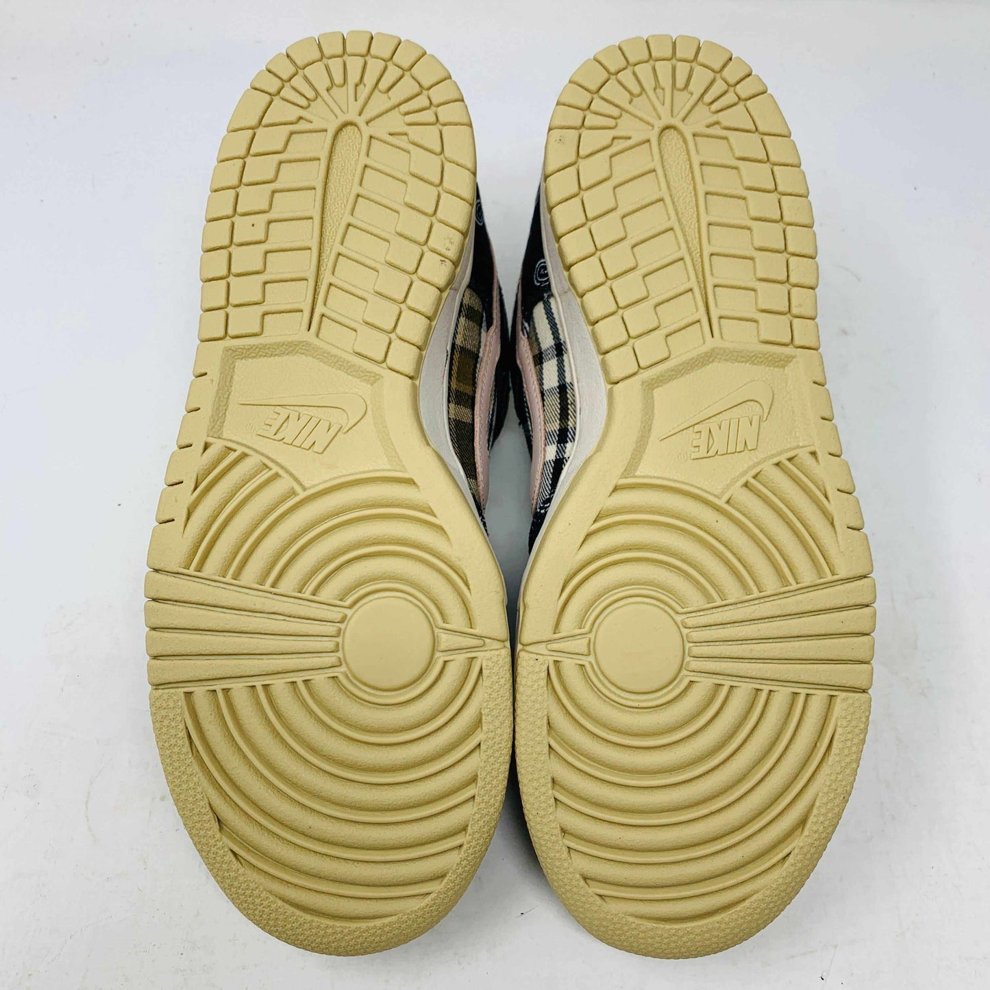 The Nike SB Dunk Low Travis Scott sneakers feature beige suede toe caps, black bandana-patterned overlays, white rope laces, authentic pink accents, and a brown label with text on the tongue. Brand new with extra laces, the interior is visible at the top.