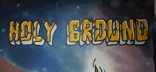 Graffiti-style mural with "Holy Ground" in bold yellow and white letters against a starry blue and purple galaxy background for Holy Ground's 4th Anniversary celebration.