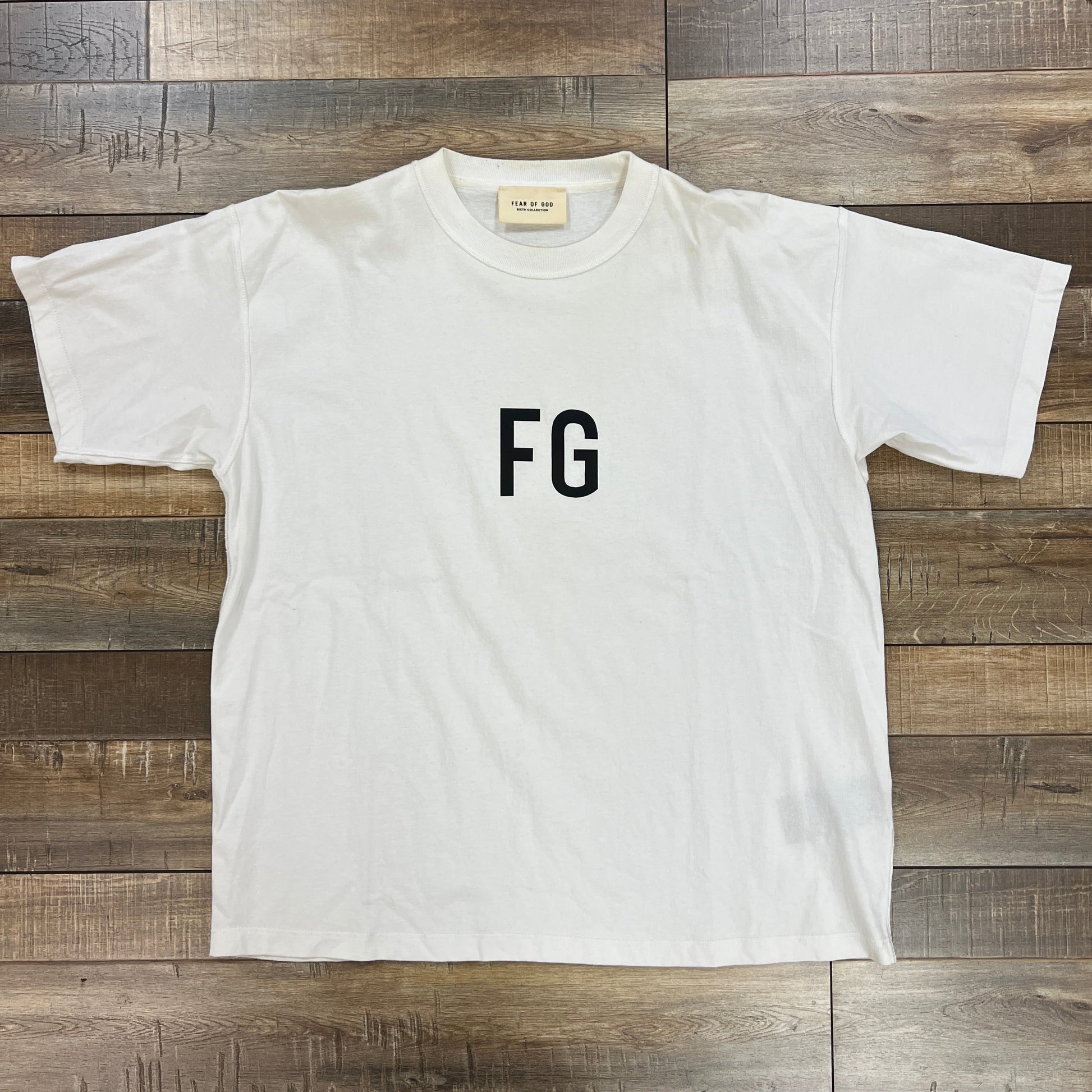 Fear of God FG logo T-shirt in white with black lettering, size S, preowned.
