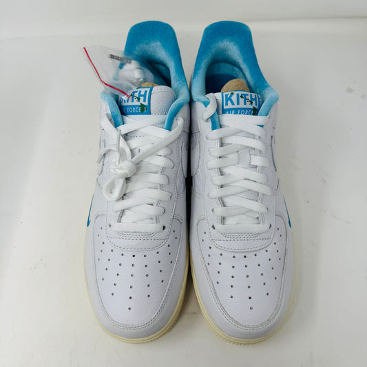 Introducing the Nike Air Force 1 Low Kith Hawaii sneaker: a fresh white design with white laces, light blue inner lining, teal swoosh, textured pattern, and cream-colored sole. Packaged in a gray shoebox, it features the word AIR embossed on the side.