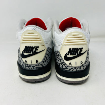 The Jordan 3 Retro White Cement Reimagined sneakers by Jordan feature a clean white upper with red accents, gray and black patterned trim on the toe and heel, white laces, and a red logo on the tongue, displayed upright on a pristine white background—perfect for everyday wear.
