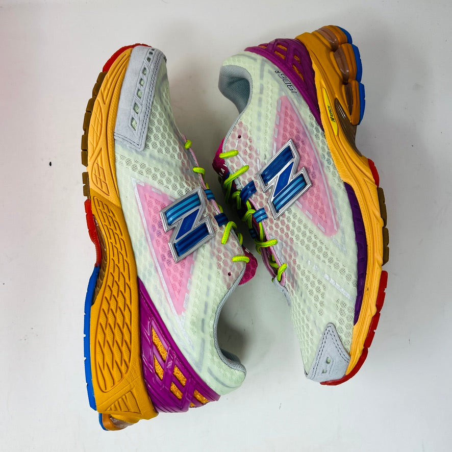 The New Balance 1906R Action Bronson Rosewater sneakers feature white mesh uppers, pink tongues with Baklava, neon green laces, blue accents, and orange midsoles. In BRAND NEW condition, theyre straight from the box.
