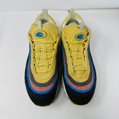 The Nike Air Max 1/97 Sean Wotherspoon sneaker, featuring a multicolored wave-like design, rests on a New Balance box and includes extra blue, white, and dark blue laces. It showcases an authentic air cushion in the sole.