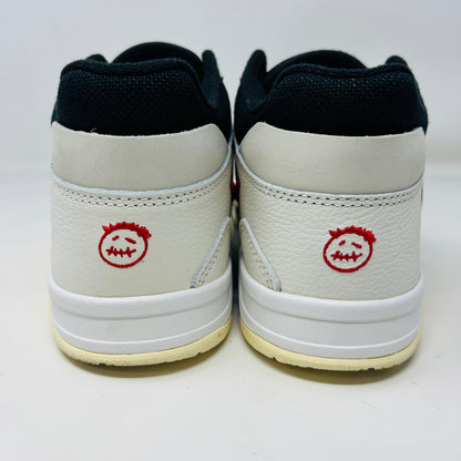 The Jordan Jumpman Jack TR Travis Scott University Red sneakers, black and white with red swooshes, rest on a brown shoe box. Three lace sets in red, cream, and black with white speckles are individually packaged in front. The box label displays sizes 9 and 10.5.