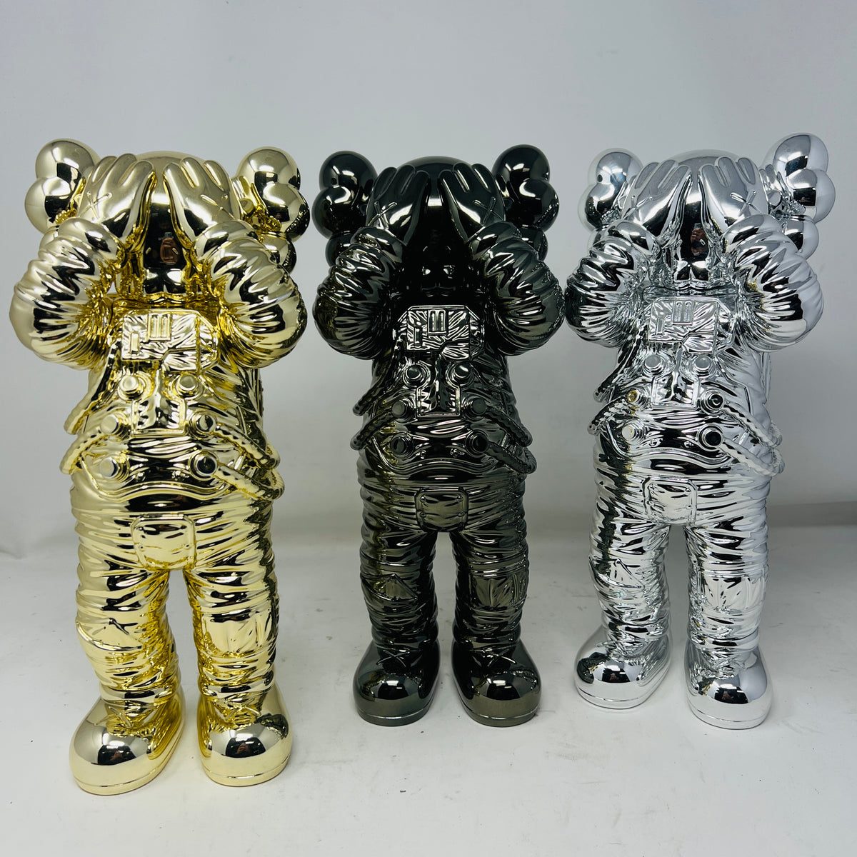 KAWS Holiday Space Figure Gold/Black/Silver Set