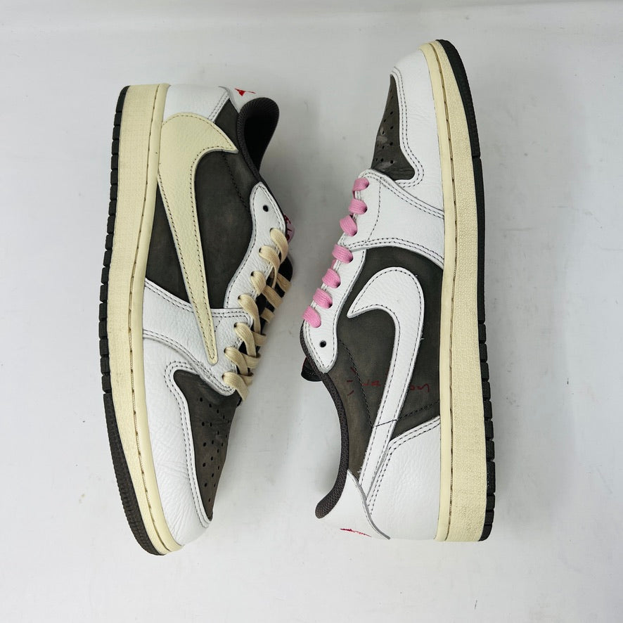 A pair of 2022 Jordan 1 Retro Low OG SP Travis Scott Reverse Mocha sneakers arranged side by side features beige laces on the left and pink on the right. Both have dark brown toe caps with clean white and brown detailing, showing minimal wear.