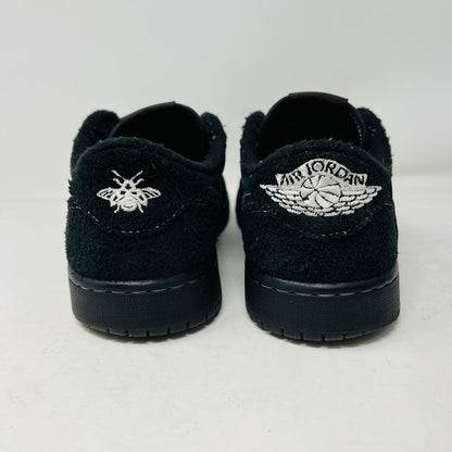 The Jordan 1 Retro Low OG SP Travis Scott Black Phantom sneaker, featured on a Nike box, flaunts black suede with a clean upper and white swoosh. Size info: US 9.5, Euro 43, UK 8.5, CM 27.5—ideal for general wear due to its visible stitching design.