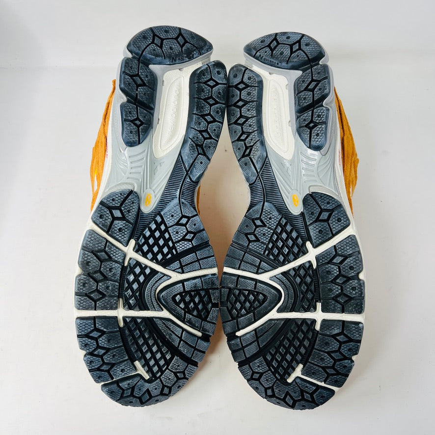 Brand new New Balance 2002R Protection Pack sneakers in Vintage Orange sit on their box, featuring a suede and mesh design, white N logo on sides, gray and white sole. Box in pristine condition with label for mens size 10.5, UK size 9.5.