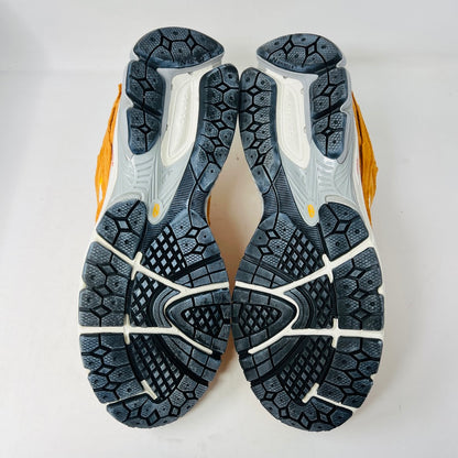Brand new New Balance 2002R Protection Pack sneakers in Vintage Orange sit on their box, featuring a suede and mesh design, white N logo on sides, gray and white sole. Box in pristine condition with label for mens size 10.5, UK size 9.5.