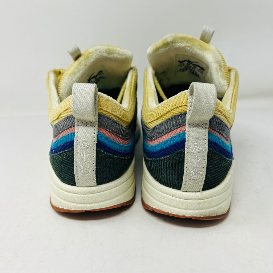 The Nike Air Max 1/97 Sean Wotherspoon sneakers showcase a colorful upper with hues of yellow, blue, and pink. They include extra blue and white laces and come in a red box labeled with size 9.5.