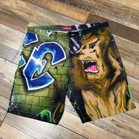 Supreme Lion's Den Painter Shorts with graffiti and lion design, preowned.