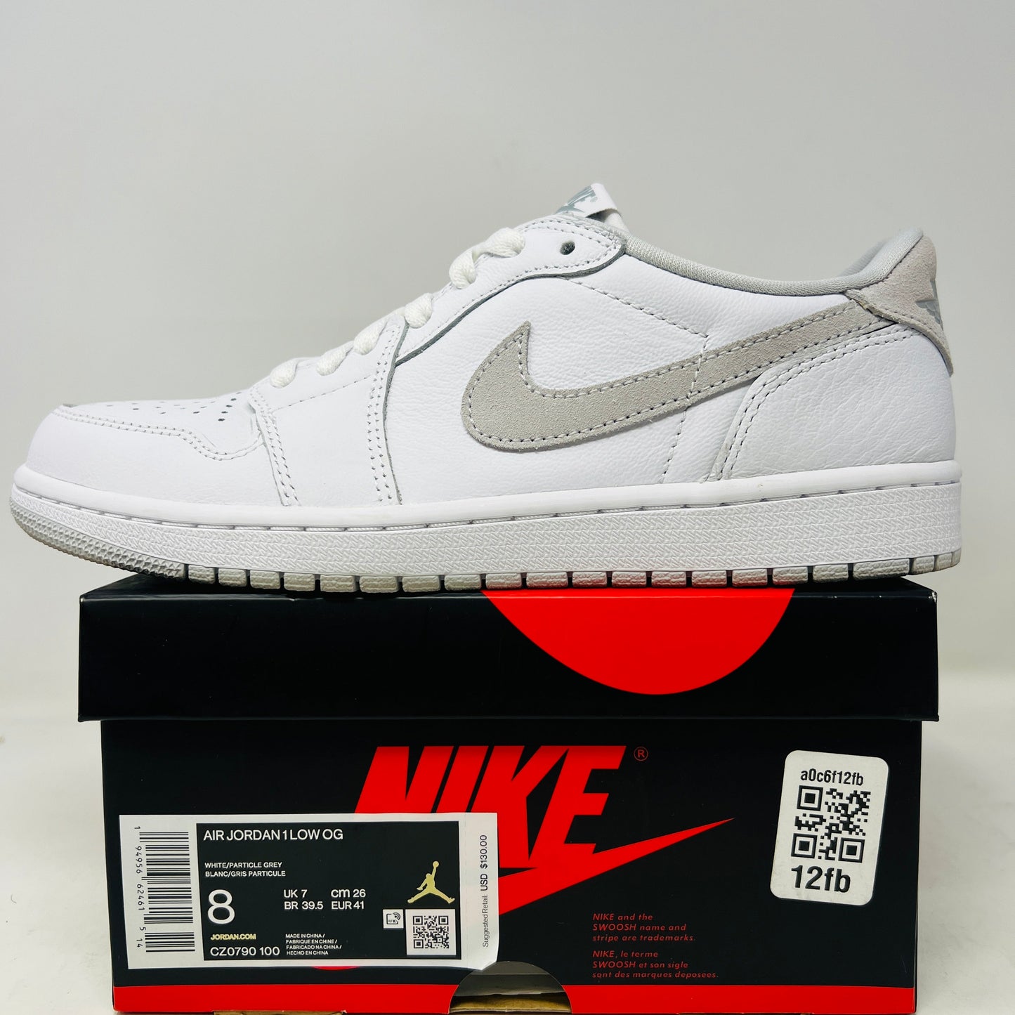 Jordan 1 Low OG Neutral Grey sneaker with a white and grey design on a Nike box. Condition 9/10, worn once.