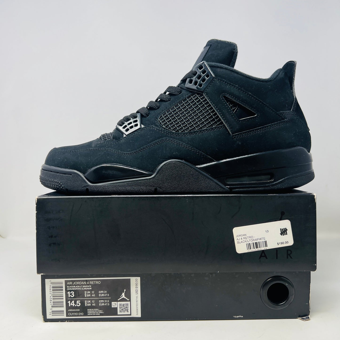 Jordan 4 Retro Black Cat 2020 sneakers in good condition, worn once, displayed on box.