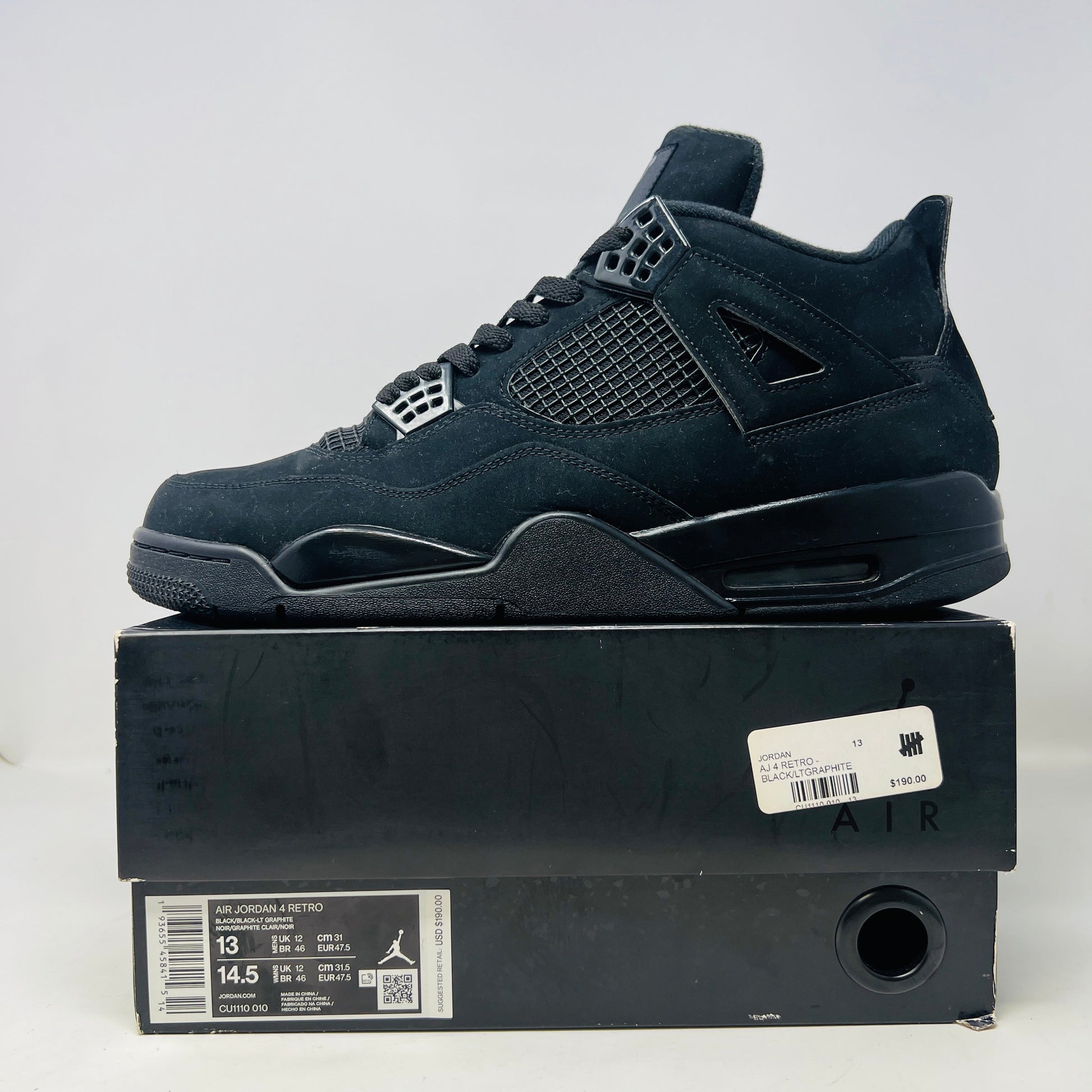 Jordan 4 Retro Black Cat 2020 sneakers in good condition, worn once, displayed on box.