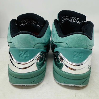 Green Nike Kobe 4 Protro Girl Dad basketball shoe with a black swoosh, silver heel accent, and suede finish sits atop a Nike shoebox. In 9/10 condition and worn once, the label indicates size 9.5 US with additional sizing details for these authentic shoes.