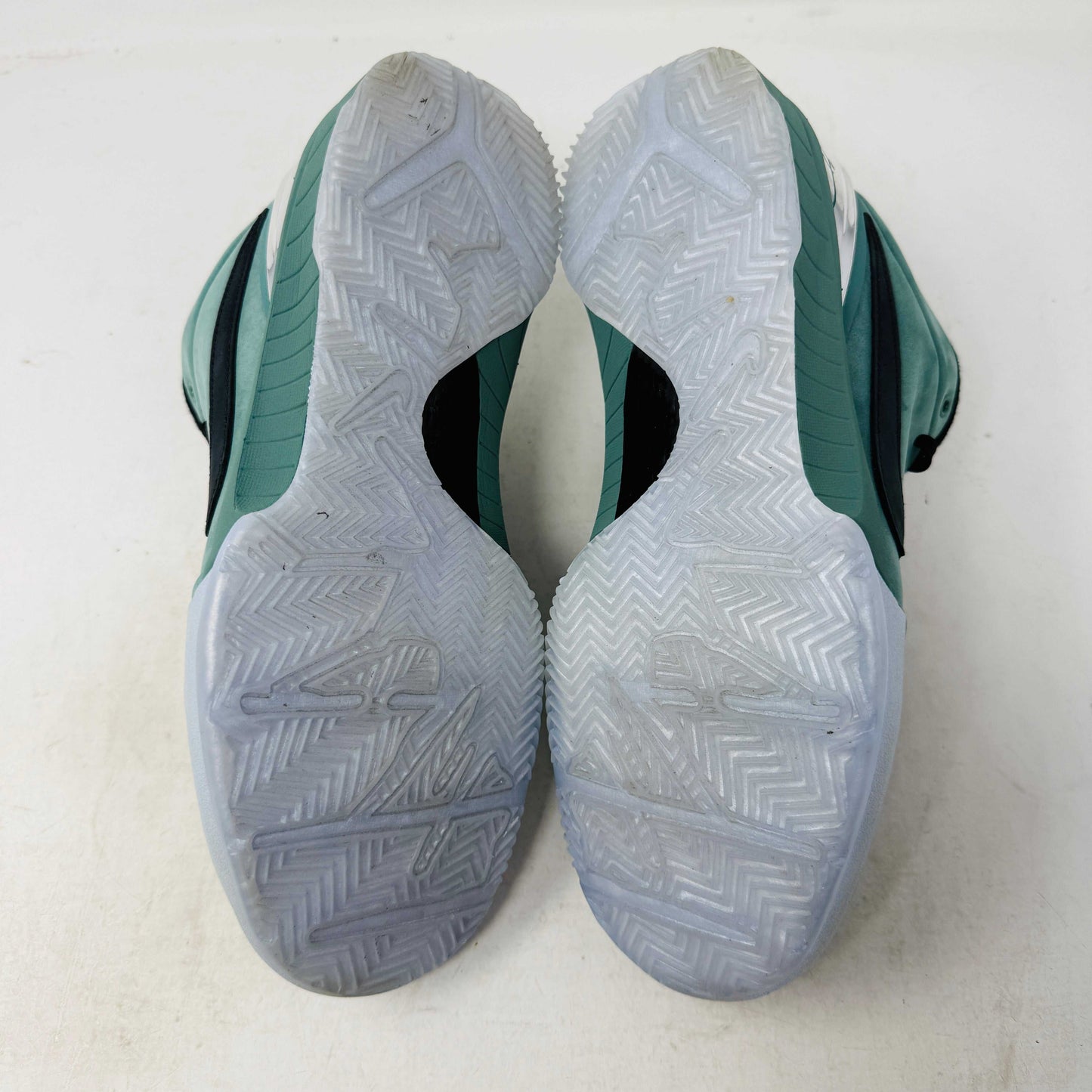 Green Nike Kobe 4 Protro Girl Dad basketball shoe with a black swoosh, silver heel accent, and suede finish sits atop a Nike shoebox. In 9/10 condition and worn once, the label indicates size 9.5 US with additional sizing details for these authentic shoes.