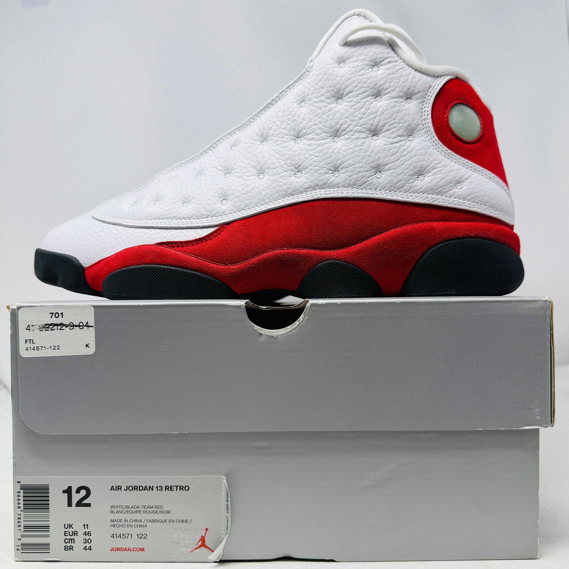 Jordan 13 Retro OG Chicago 2017 sneaker with white leather uppers and red suede detail on box size 12