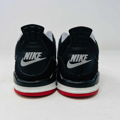 The Jordan 4 Retro Bred (2019) (PS) in black and red, featuring clean uppers with a white midsole and gray accents, sits on its original black shoebox. The box displays size, product details, and the iconic Jumpman logo, underscoring these authentic shoes from Jordans 2019 collection.