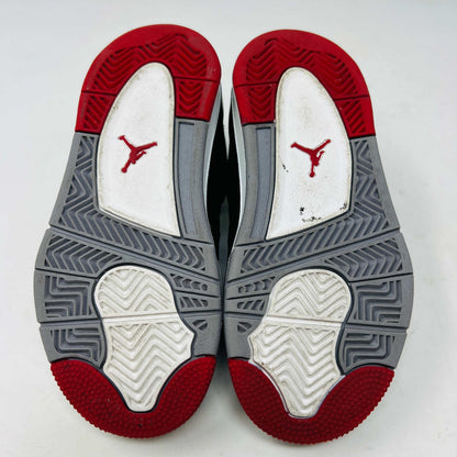 The Jordan 4 Retro Bred (2019) (PS) in black and red, featuring clean uppers with a white midsole and gray accents, sits on its original black shoebox. The box displays size, product details, and the iconic Jumpman logo, underscoring these authentic shoes from Jordans 2019 collection.