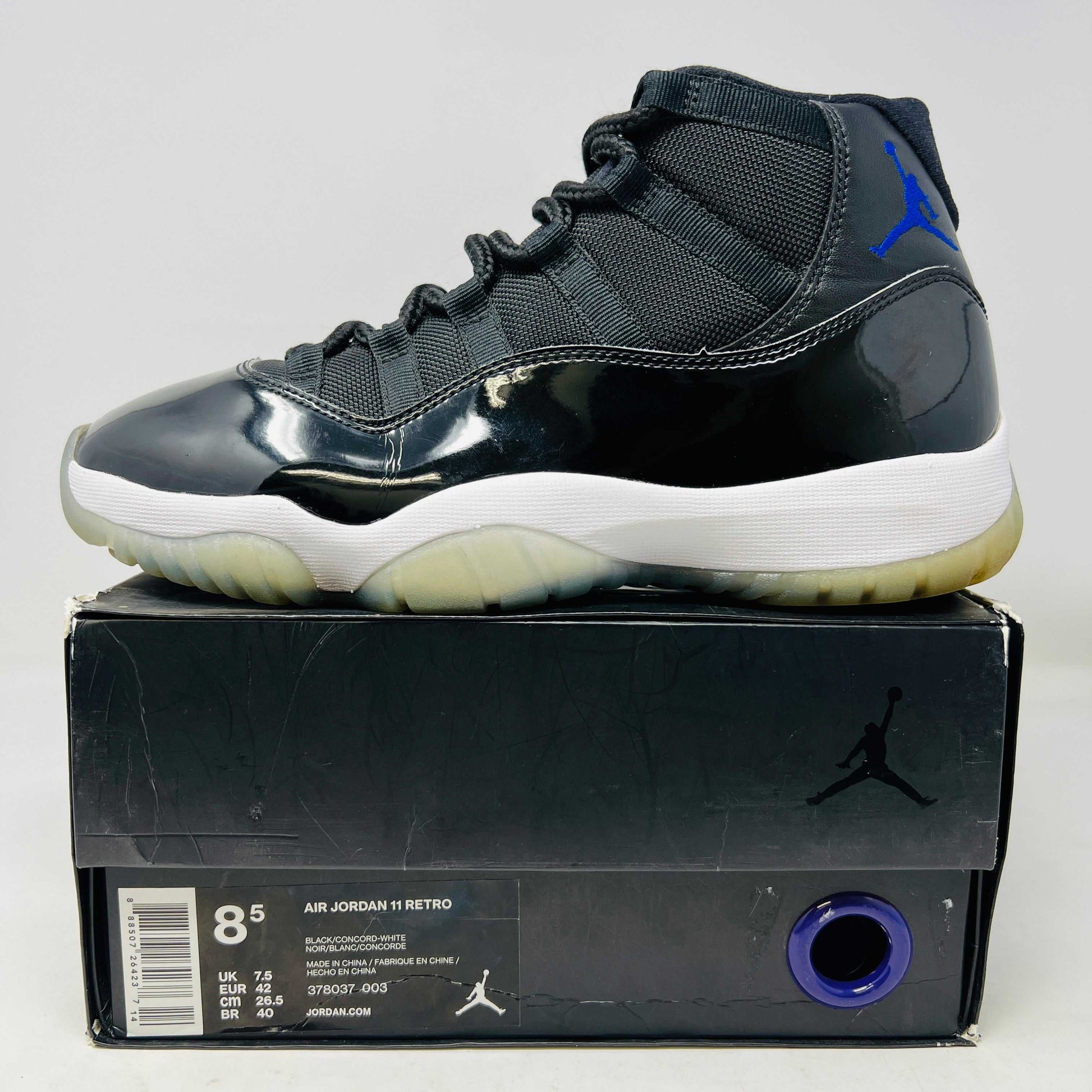 Jordan 11 Retro Space Jam 2016 sneakers with slight yellowing on soles, ripped sleeve box.