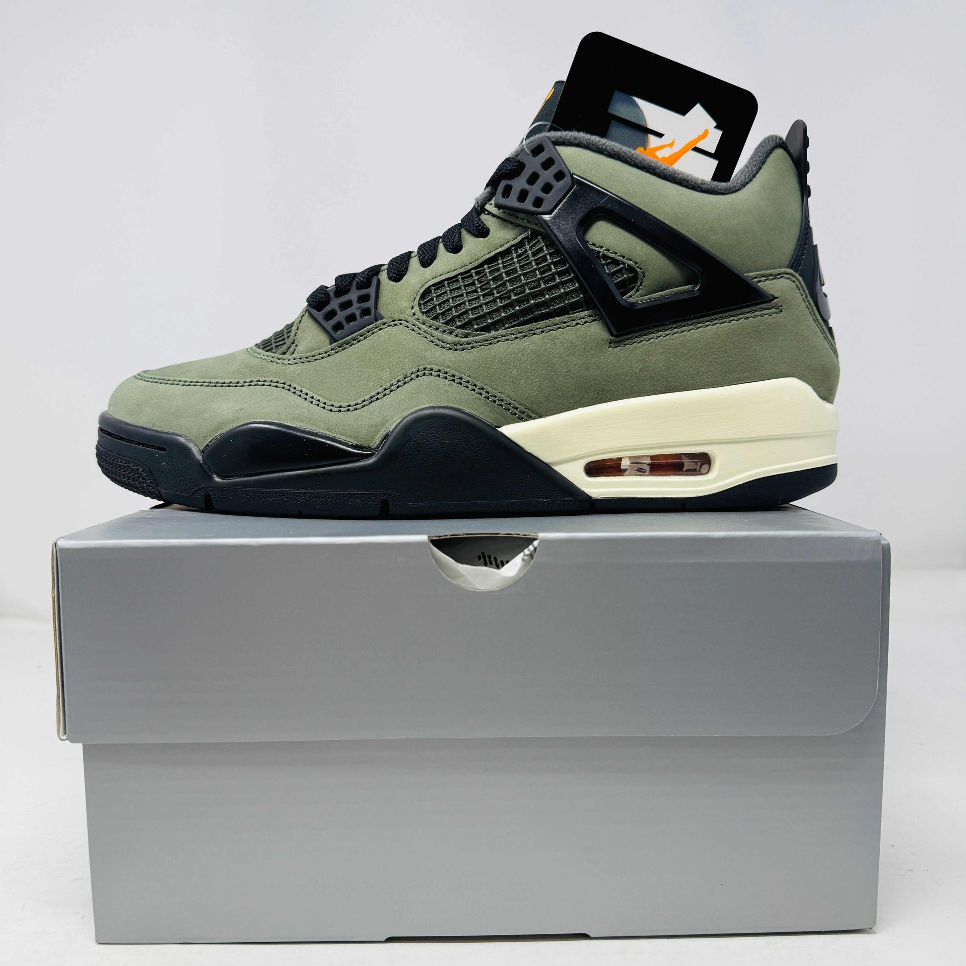 Jordan 4 Retro OG SP Undefeated sneaker in olive green and black on gray box, new condition with hang tag 2025