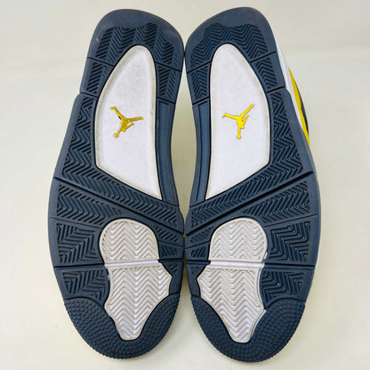 The Jordan 4 Retro Lightning (2021) in yellow rests on its matching box with a size label. Featuring clean uppers, blue accents, a visible air unit in the heel, and a black Jumpman logo on the box, note that returns are not accepted.