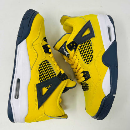 The Jordan 4 Retro Lightning (2021) (GS) sneaker, in bright yellow with black/gray accents and a visible air unit, is displayed on its matching shoebox. Both the box and heel sport the iconic Jumpman logo, with size details confirming authenticity from the Jordan brand.