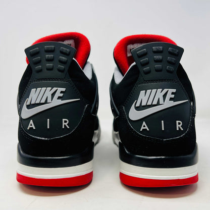 A Jordan 4 Retro Bred (2019) sneaker, featuring black and red colors, clean uppers, slight star loss, mesh paneling, grey accents, and a visible air unit in the heel sits on its box. The box showcases size details and the iconic Jumpman logo to verify its authentic.