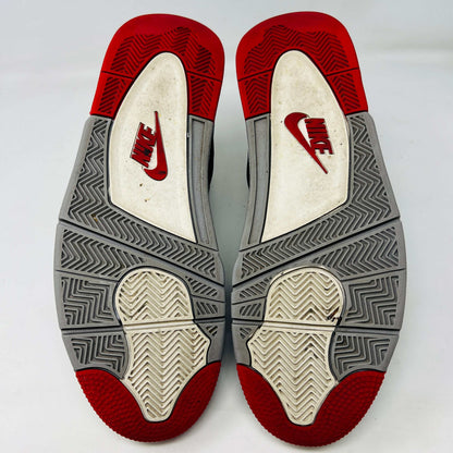 A Jordan 4 Retro Bred (2019) sneaker, featuring black and red colors, clean uppers, slight star loss, mesh paneling, grey accents, and a visible air unit in the heel sits on its box. The box showcases size details and the iconic Jumpman logo to verify its authentic.