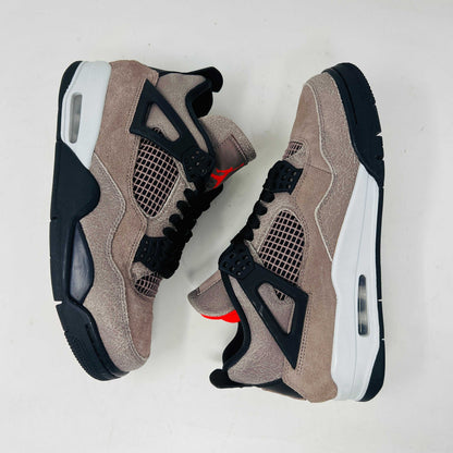 The Jordan 4 Retro Taupe Haze sneaker is showcased on its speckled brown shoebox. Released in 2021, it boasts black mesh accents, a visible air unit, and the Jumpman logo on the tongue. Size and style details are printed on the box.