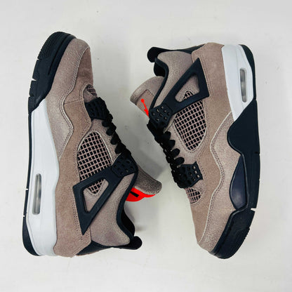 The Jordan 4 Retro Taupe Haze sneaker is showcased on its speckled brown shoebox. Released in 2021, it boasts black mesh accents, a visible air unit, and the Jumpman logo on the tongue. Size and style details are printed on the box.