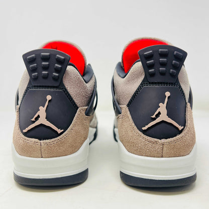 The Jordan 4 Retro Taupe Haze sneaker is showcased on its speckled brown shoebox. Released in 2021, it boasts black mesh accents, a visible air unit, and the Jumpman logo on the tongue. Size and style details are printed on the box.