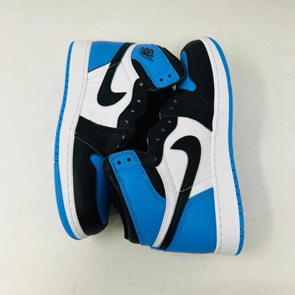 A pair of 100% authentic Jordan 1 Retro High OG UNC Toe (GS) sneakers in black, white, and blue sits on a matching blue box. The shoes feature the iconic black Nike swoosh logo on the side.