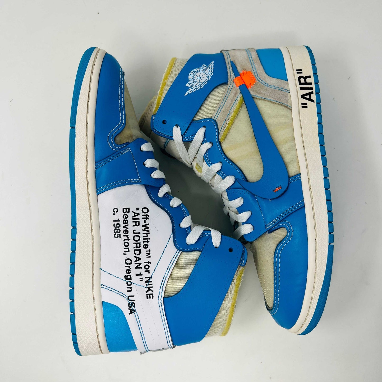 Jordan 1 Retro High Off-White University Blue sneakers with clean uppers and light wear, 2018 model.