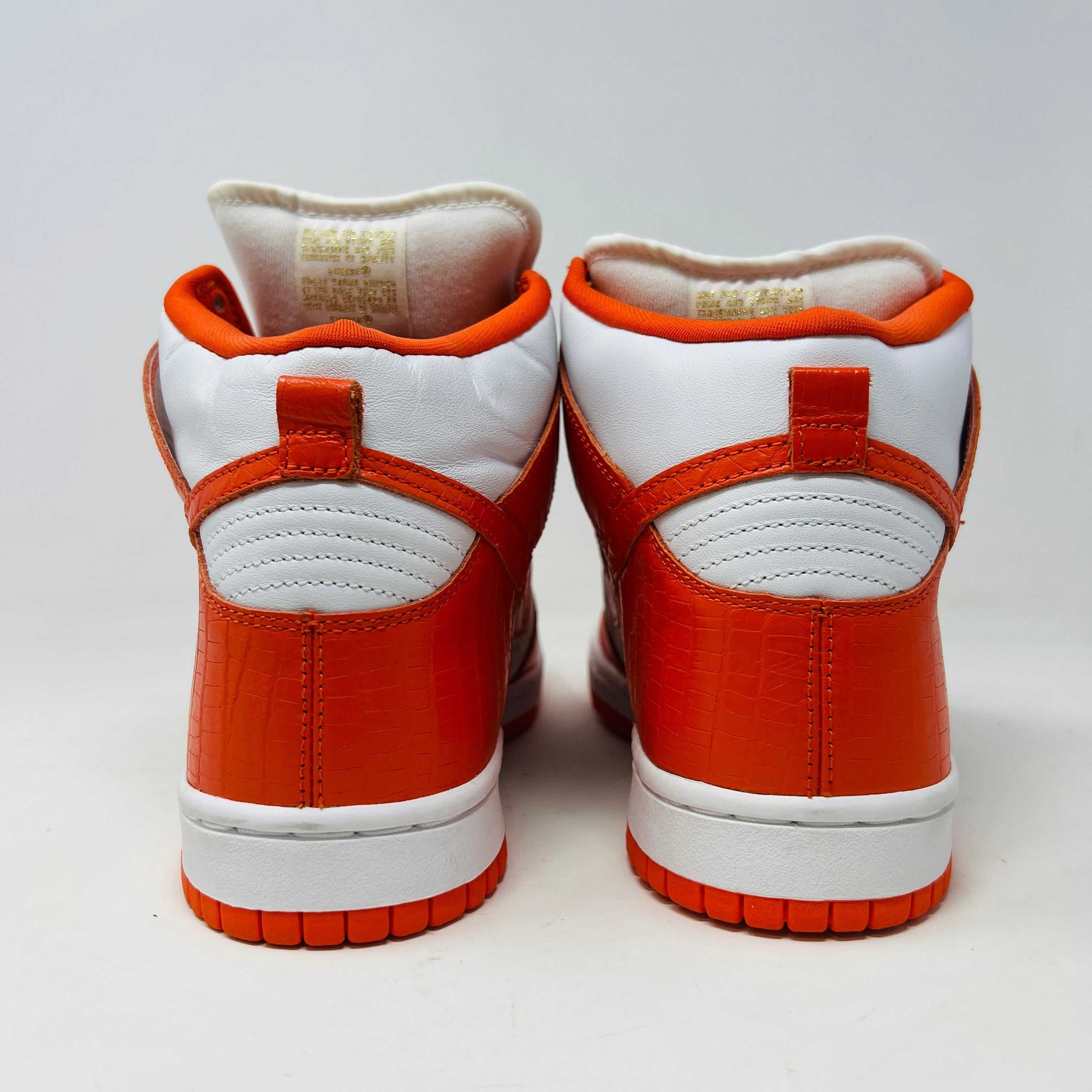 The Nike Dunk High Pro SB Supreme Orange Stars sneaker features an orange and white color scheme with star patterns on the side, a textured finish, and comes with authentic orange and white laces in a separate package.