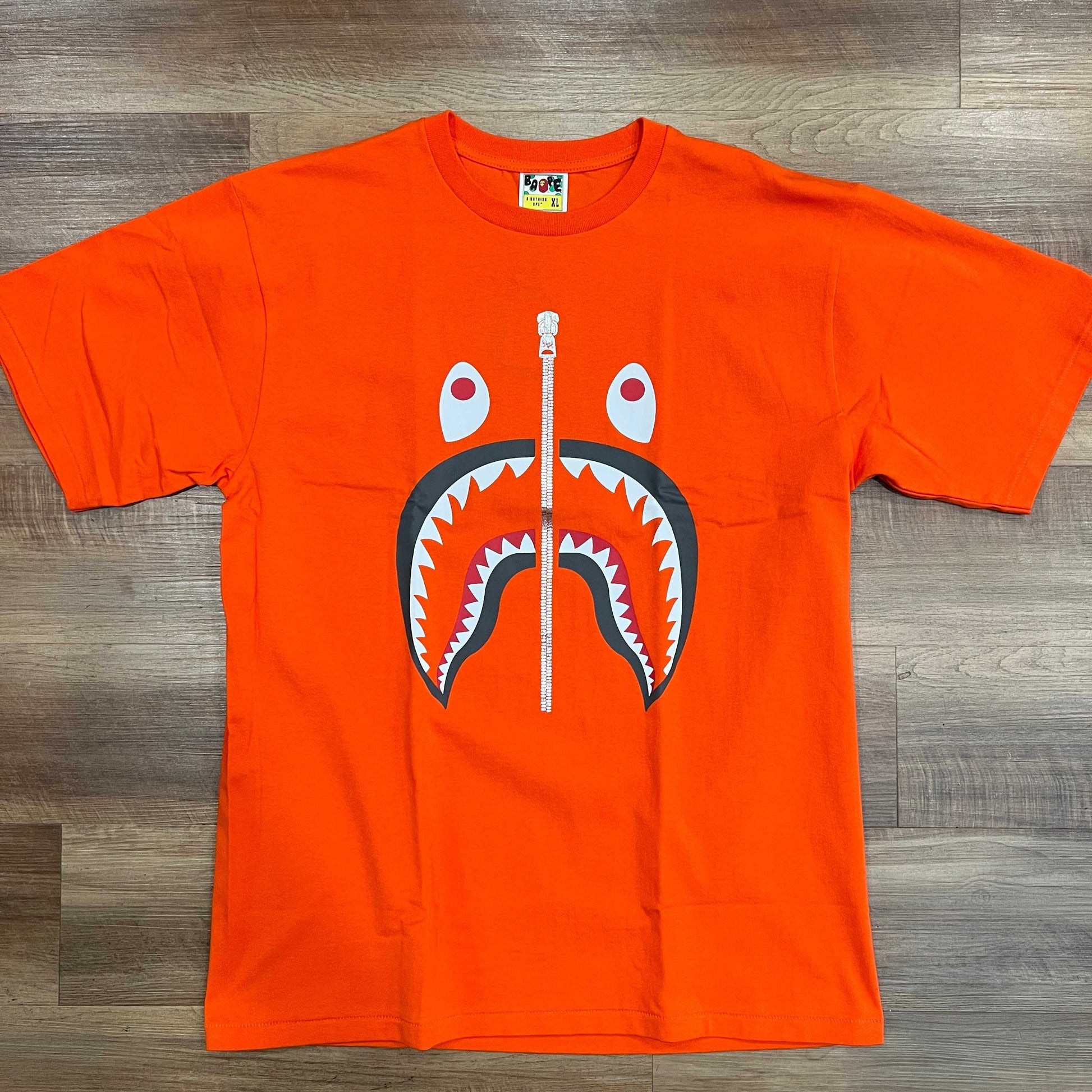 A BATHNIG APE Men's SHARK TEE in orange, size XL, brand new condition.
