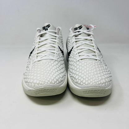 The Nike Kobe 6 Protro Sail All-Star shoes, featuring white textured patterns and black swoosh details with star designs, are elegantly displayed on a sleek black shoebox.