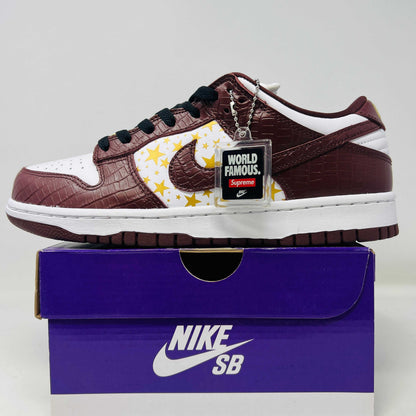 Nike SB Dunk Low Supreme Barkroot sneakers in brand new condition on a purple box.