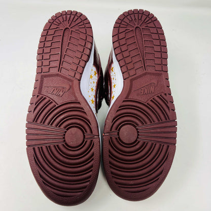 Introducing the new Nike SB Dunk Low Supreme Barkroot sneakers by Nike, featuring a star pattern with a World Famous Supreme tag and housed in a striking purple Nike SB box.