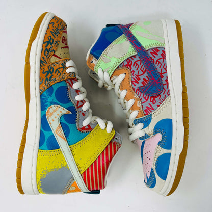 The Nike SB Dunk High Thomas Campbell What The Dunk, a colorful high-top sneaker, features a mix of patterns and textures with a blue Nike logo. It is on a teal SB box, BRAND NEW and 100% Authentic. An orange lace lies beside this shoe featuring blue, green, pink, and tan elements.