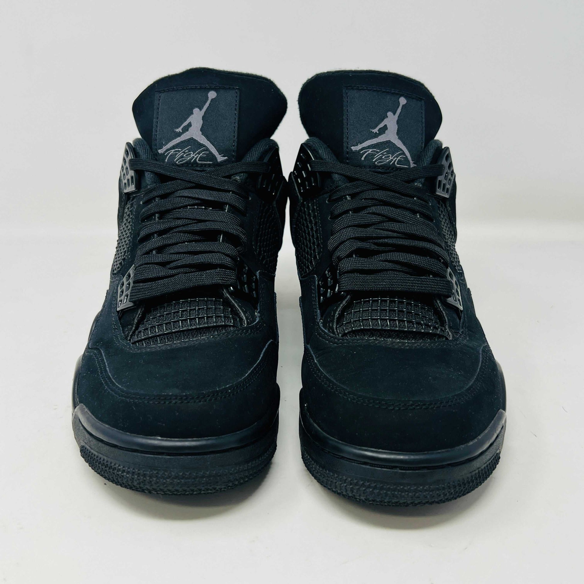 Jordan 4 Retro Black Cat (2020) sneakers in black, condition 8.5/10, displayed on their original box.